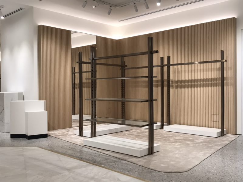 Custom fluted wood wall panels in a luxury retail interior — custom carpentry by Kefi Creations